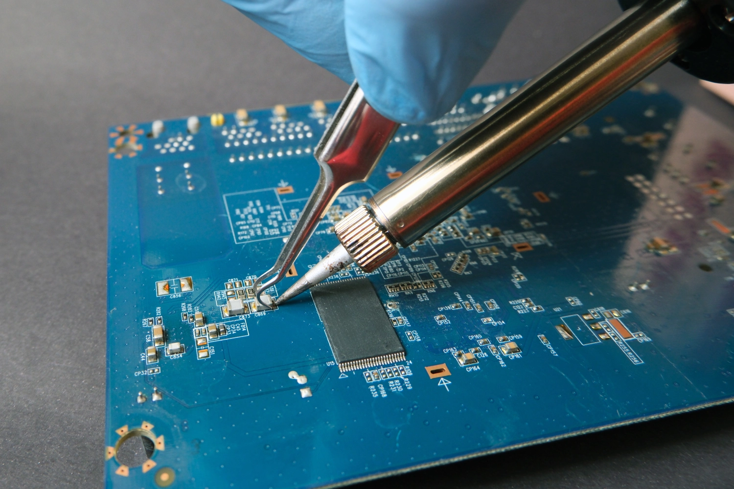 Soldering electronic components on circuit board.